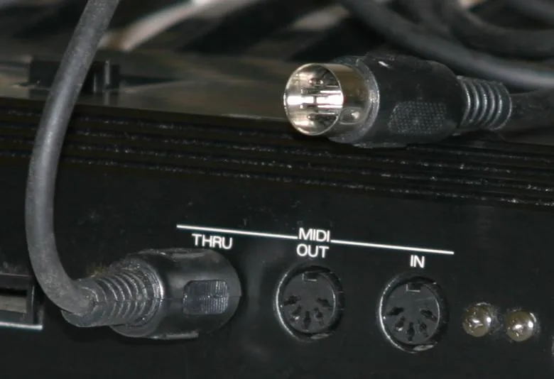 MIDI THRU, OUT, and IN ports on an instrument with a 5-pin DIN plug